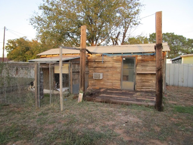 back of house with an outdoor structure