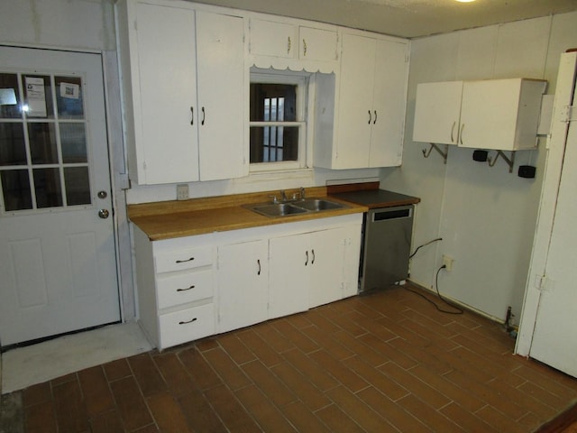 kitchen with sink, white refrigerator, white cabinets, and dishwasher