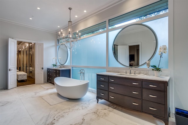 bathroom with a washtub, an inviting chandelier, crown molding, and vanity