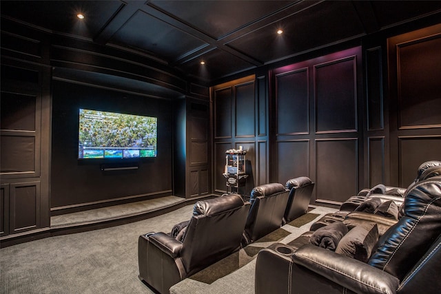 cinema room featuring beam ceiling, coffered ceiling, and carpet