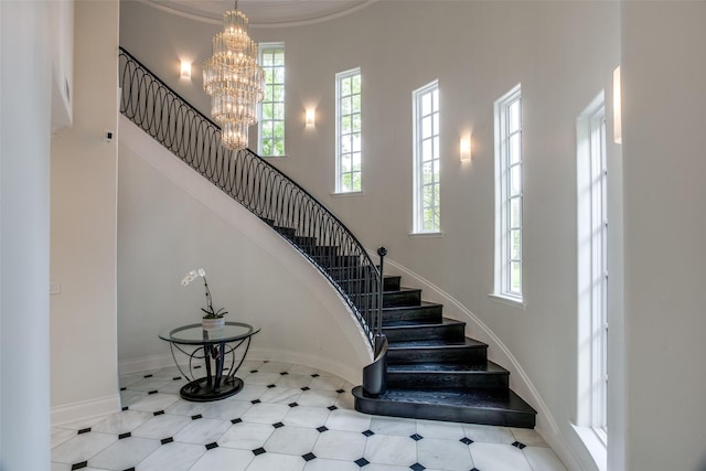 stairs with a chandelier