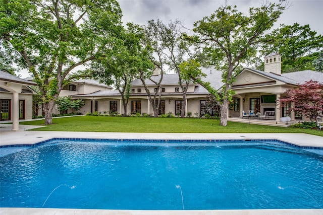 view of pool featuring a yard and a patio area