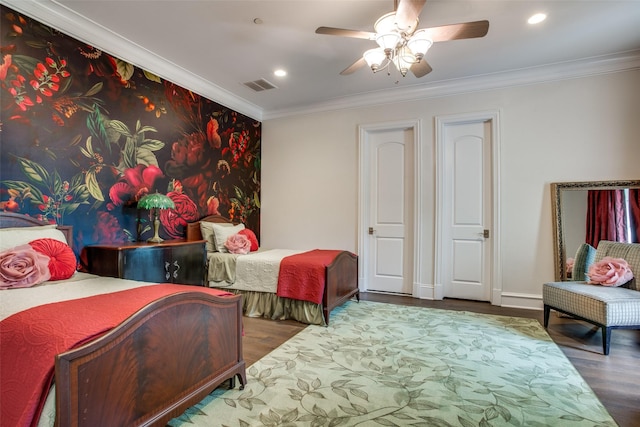 bedroom with ceiling fan, ornamental molding, and dark wood-type flooring