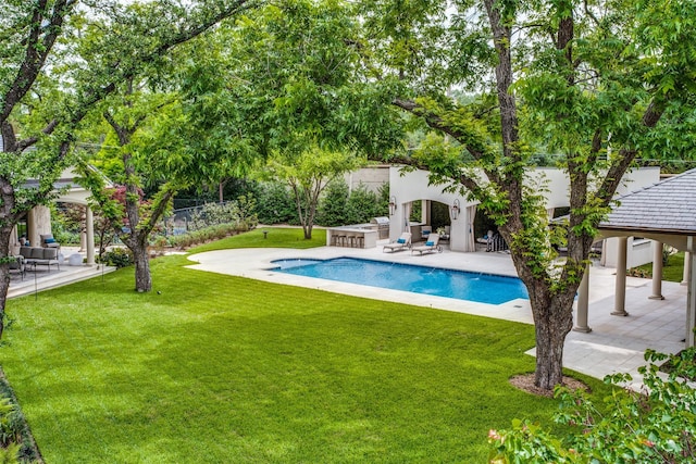 view of pool featuring a lawn and a patio