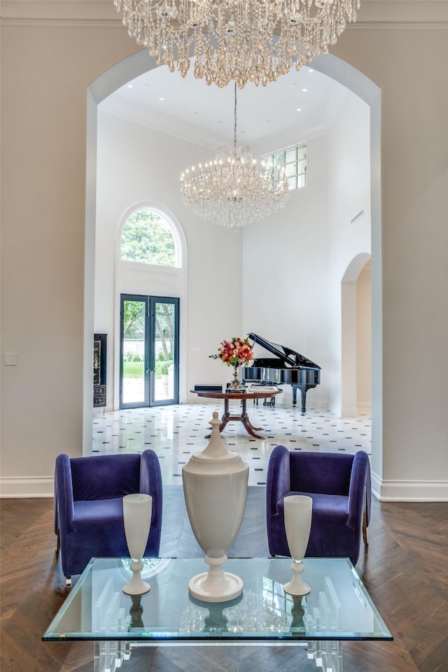 dining space with ornamental molding, french doors, a chandelier, and parquet floors