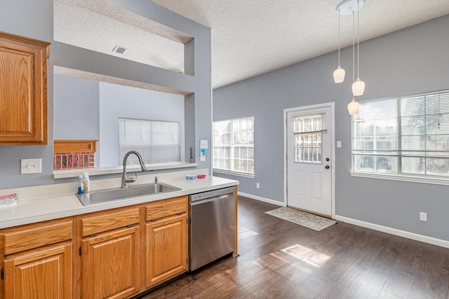 kitchen featuring dark wood-type flooring, a textured ceiling, dishwasher, decorative light fixtures, and sink