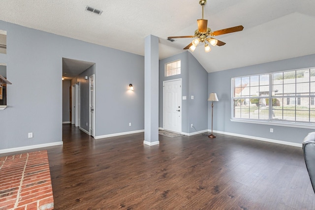 unfurnished living room with lofted ceiling, a textured ceiling, ceiling fan, and dark hardwood / wood-style flooring