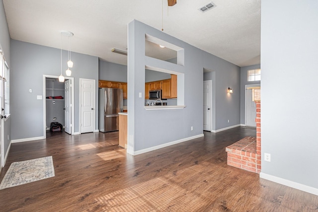 unfurnished living room with ceiling fan and dark hardwood / wood-style flooring