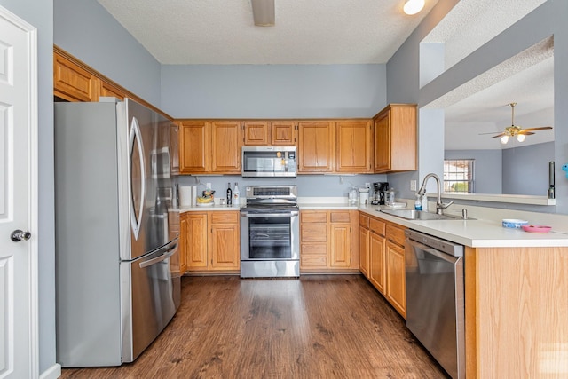 kitchen with stainless steel appliances, a textured ceiling, ceiling fan, and sink