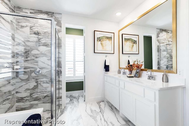 bathroom featuring a shower with door and vanity