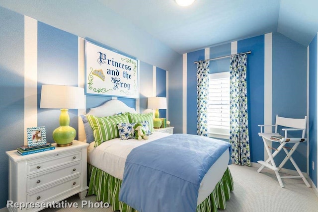 bedroom with vaulted ceiling and carpet flooring