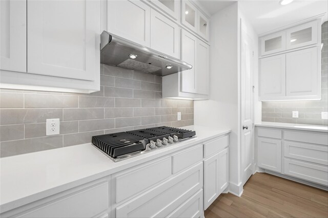 bar with stainless steel dishwasher, green cabinetry, white cabinetry, and sink