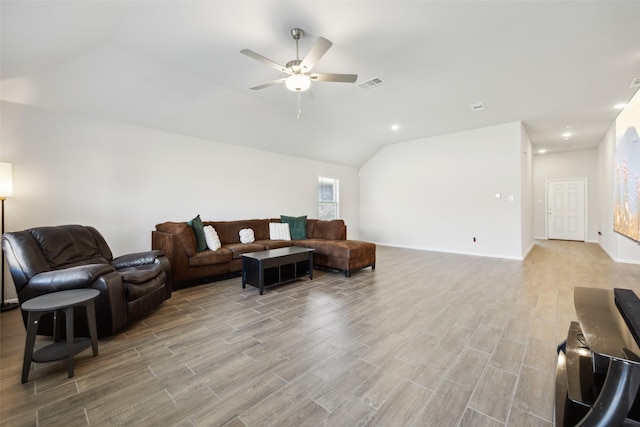 living room featuring ceiling fan and vaulted ceiling