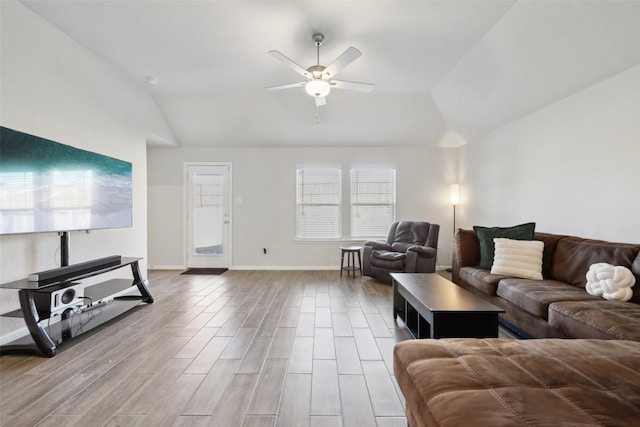 living room with ceiling fan and lofted ceiling