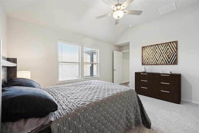 carpeted bedroom with vaulted ceiling and ceiling fan