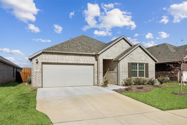 view of front of home featuring a garage and a front yard