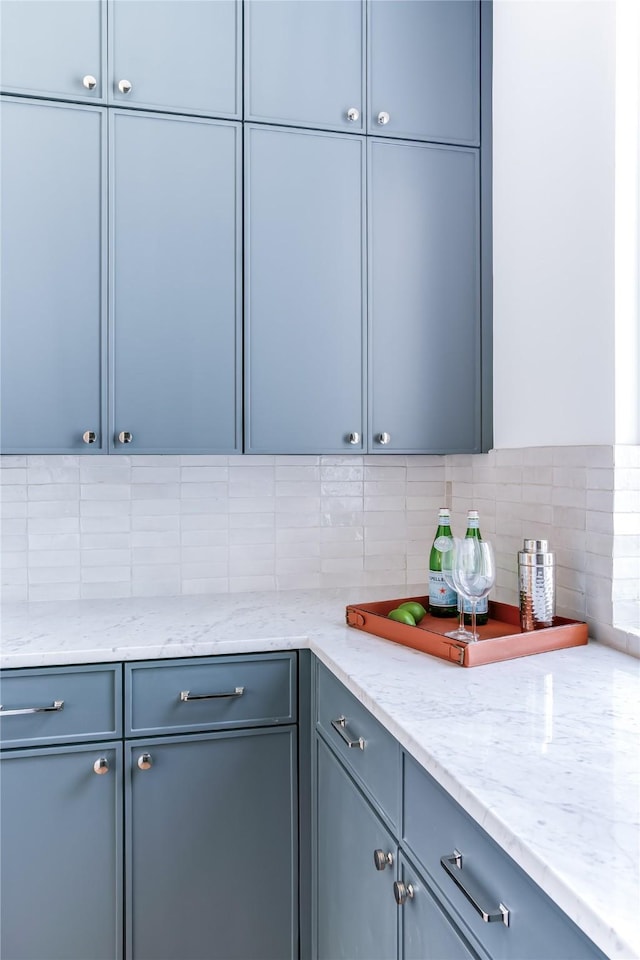 kitchen with light stone counters and decorative backsplash