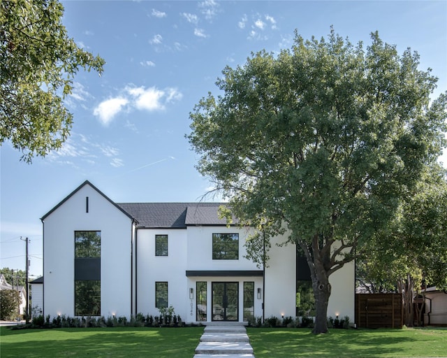 view of front facade with french doors and a front lawn