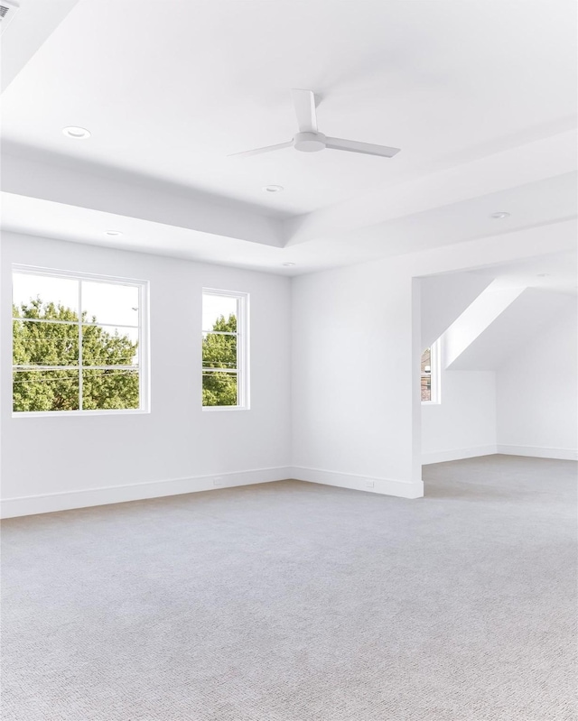 unfurnished room featuring ceiling fan and light carpet