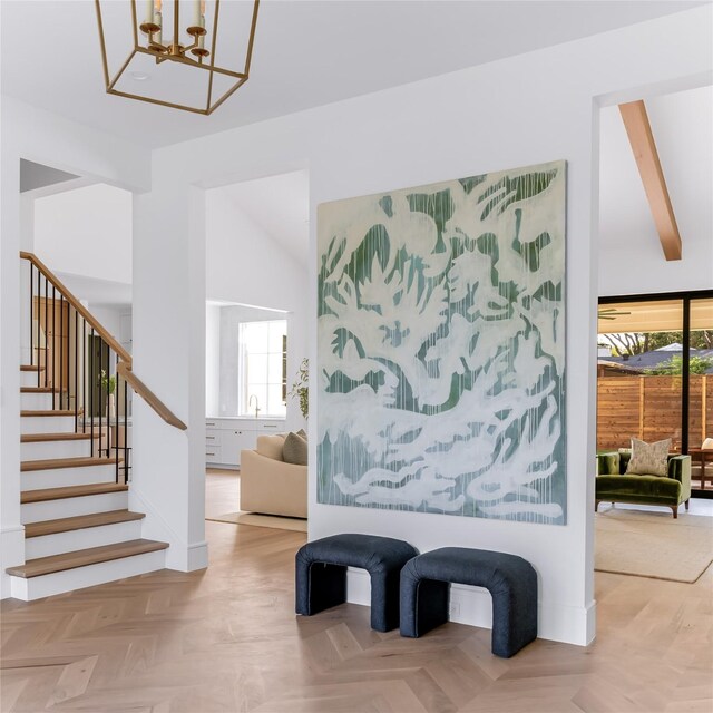 interior space featuring a chandelier and light parquet flooring