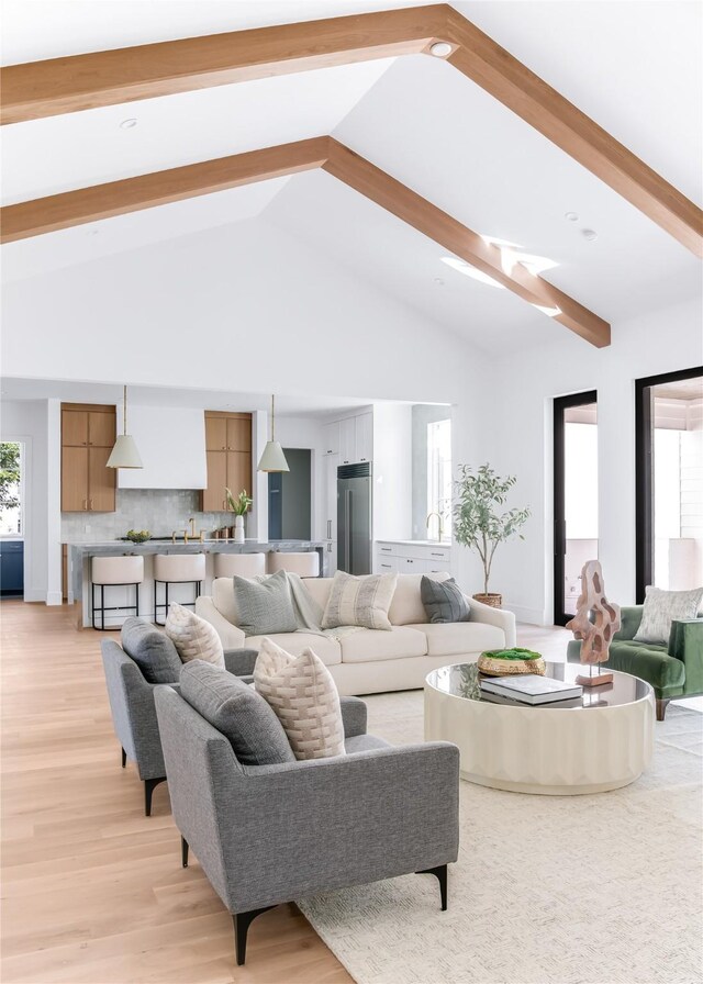 living room with light wood-type flooring and vaulted ceiling