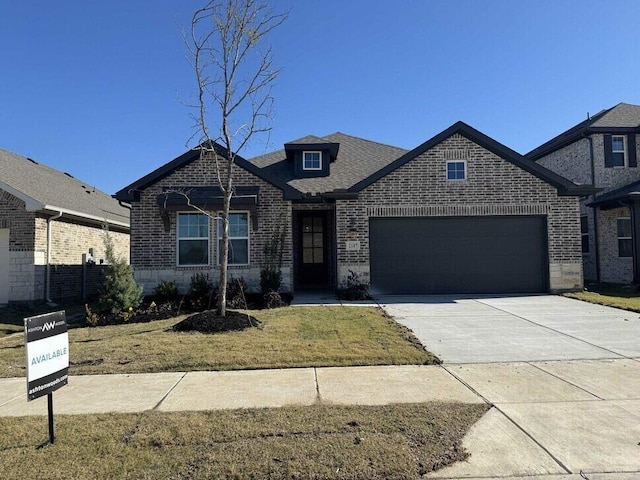 view of front of house featuring a front yard and a garage