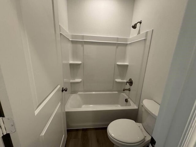 bathroom featuring toilet, wood-type flooring, and tub / shower combination