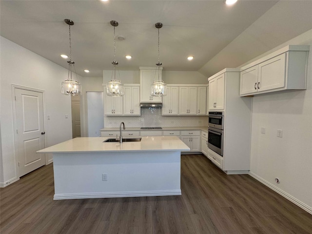 kitchen with sink, white cabinetry, tasteful backsplash, black electric cooktop, and a kitchen island with sink