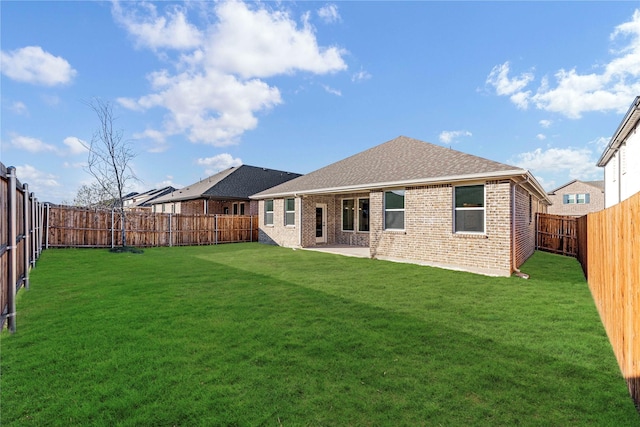 back of property with a patio area and a yard