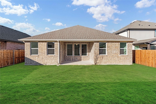 back of house with a patio area and a yard