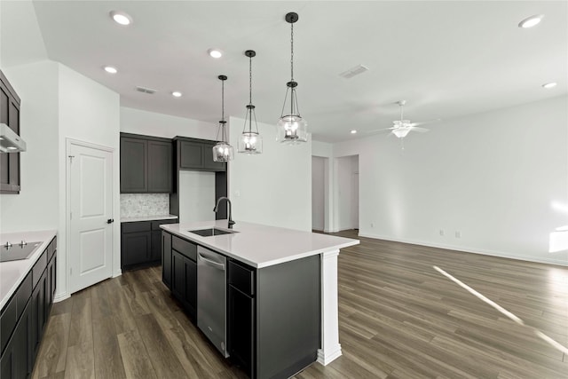 kitchen with stainless steel dishwasher, a center island with sink, tasteful backsplash, ceiling fan, and sink