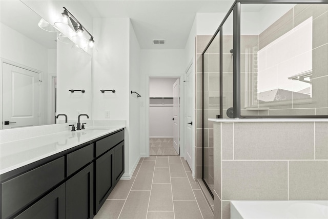 bathroom featuring an enclosed shower, tile patterned floors, and vanity