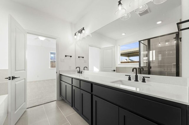 bathroom with tile patterned flooring, vanity, and a shower with shower door