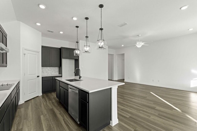 kitchen with sink, dishwasher, ceiling fan, tasteful backsplash, and a center island with sink