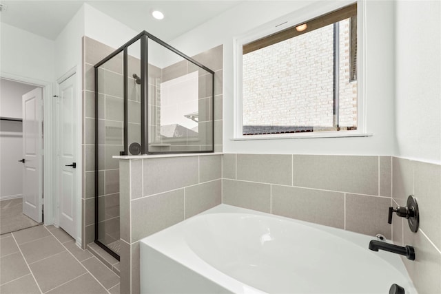 bathroom with separate shower and tub and tile patterned flooring