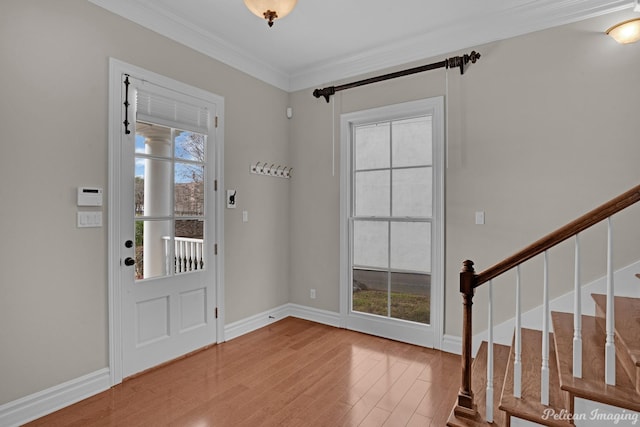 entrance foyer with hardwood / wood-style flooring and ornamental molding