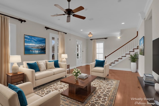 living room with ornamental molding, ceiling fan, and hardwood / wood-style flooring