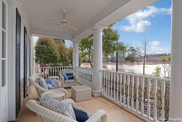 balcony featuring a porch, ceiling fan, and a water view