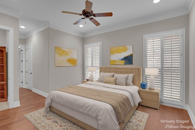 bedroom with light wood-type flooring, ceiling fan, and crown molding