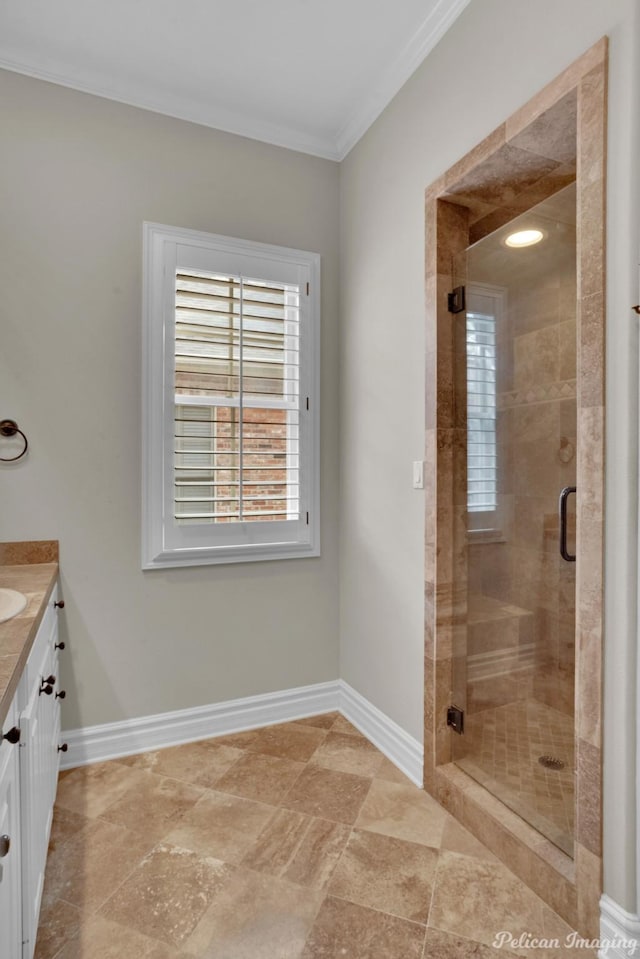 bathroom featuring a shower with door, crown molding, and vanity