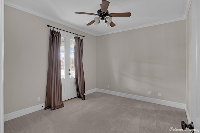 spare room with ornamental molding, ceiling fan, and light carpet