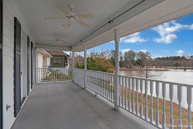 balcony featuring ceiling fan and a water view