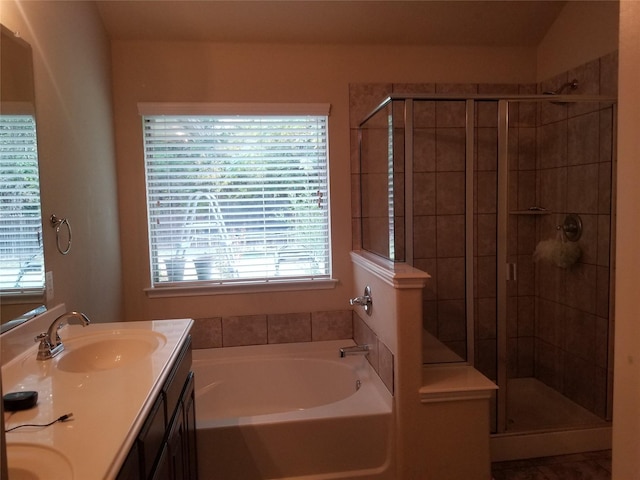 bathroom with vanity, plenty of natural light, and plus walk in shower