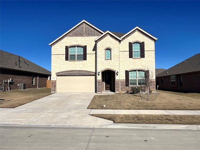 french provincial home with central air condition unit and a garage