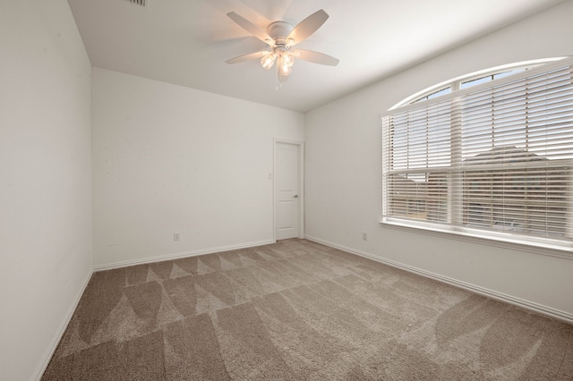 unfurnished room featuring ceiling fan and carpet