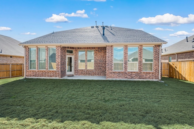 rear view of property with a patio area and a yard