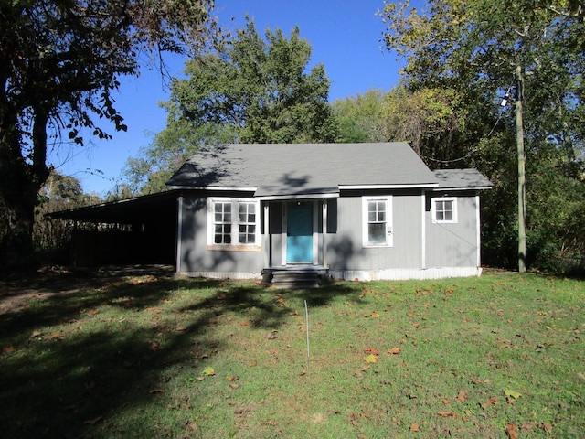 rear view of house with a yard and a carport