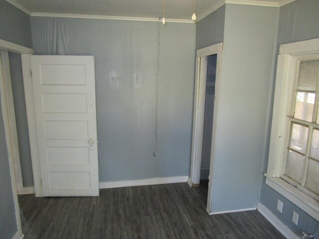 unfurnished room with dark hardwood / wood-style flooring and crown molding