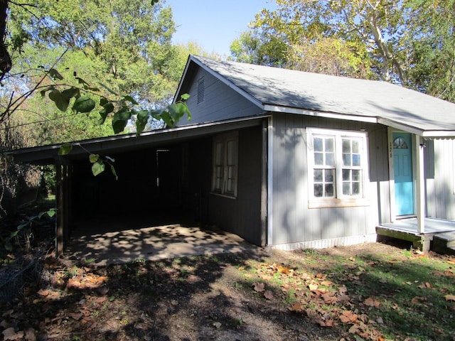 view of side of home with a carport