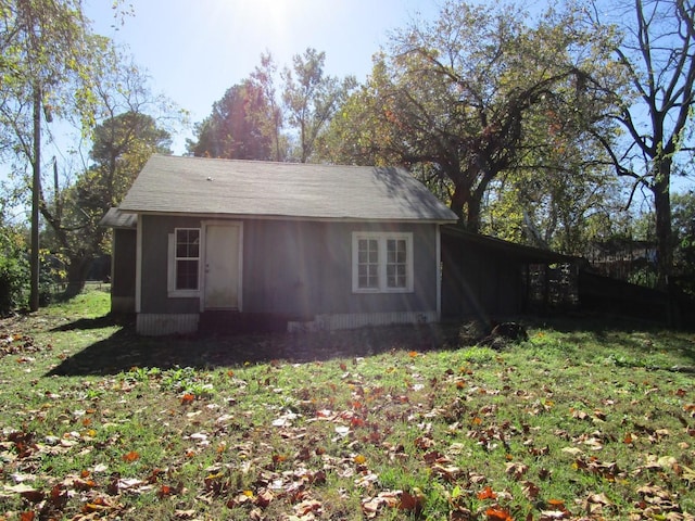 view of outbuilding with a lawn